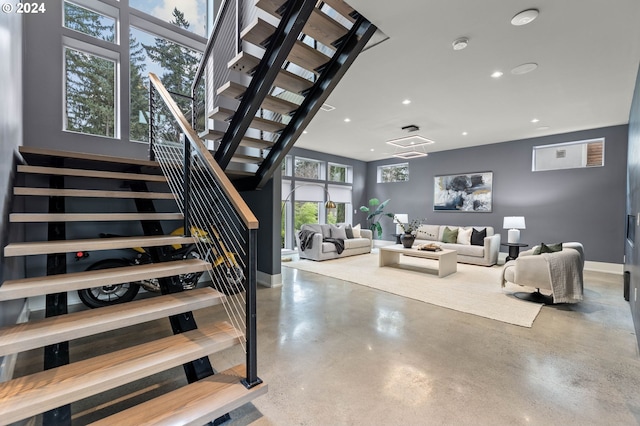 stairs featuring concrete flooring