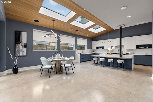 dining area with a notable chandelier, wooden ceiling, and vaulted ceiling