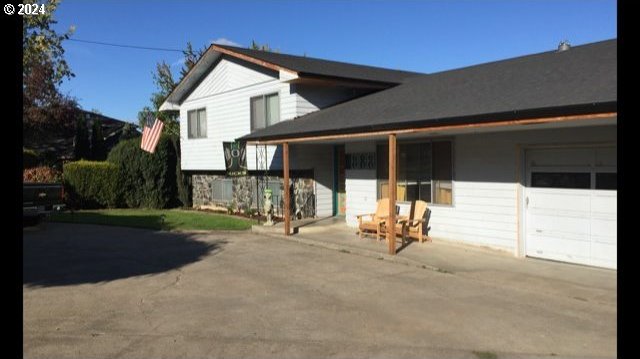 9888 SE 172nd Ave, Happy Valley, OR 97086 - view of front of home with covered porch and a garage