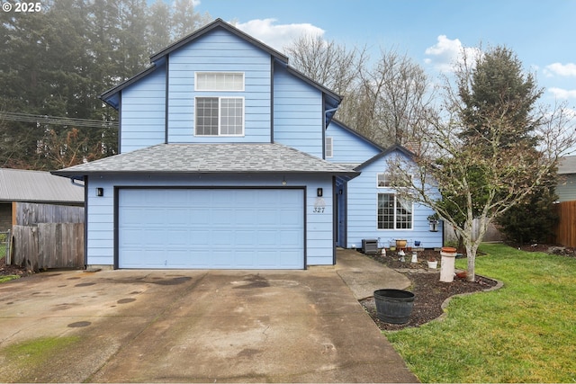 view of property with a front yard and a garage