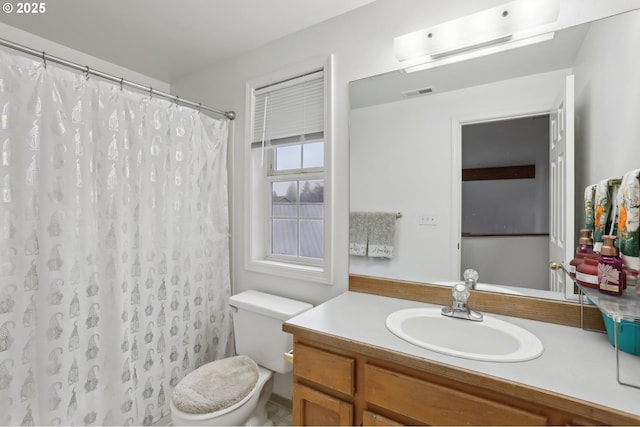 bathroom with toilet, vanity, and a shower with curtain