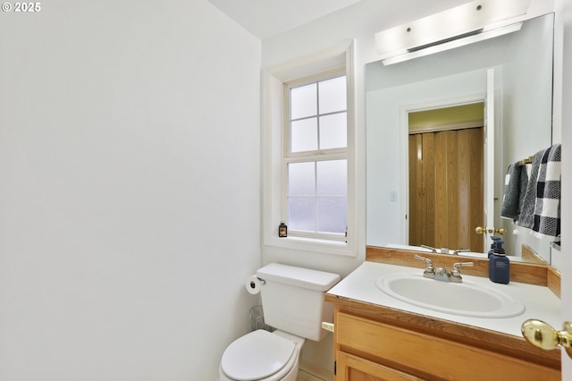 bathroom featuring toilet and vanity