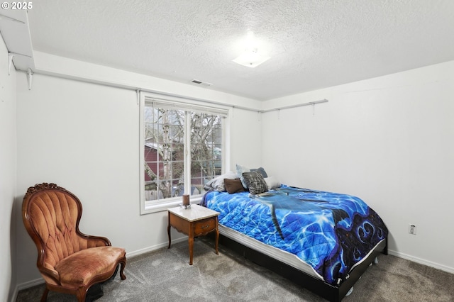 carpeted bedroom featuring a textured ceiling