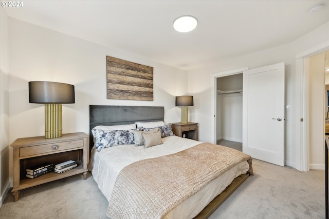 bedroom with light carpet and a closet