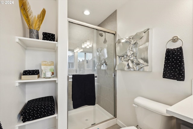 bathroom featuring toilet and an enclosed shower