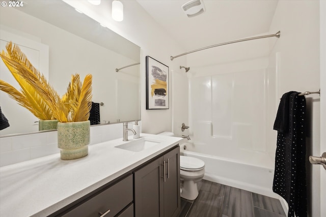 full bathroom with bathtub / shower combination, vanity, hardwood / wood-style flooring, and toilet