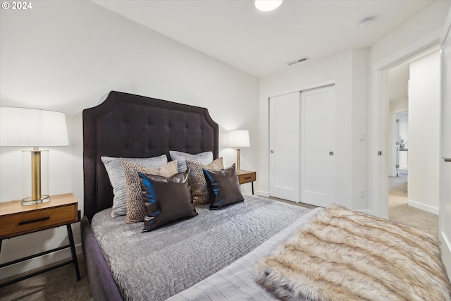 bedroom featuring light carpet and a closet