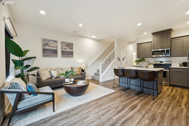 2828 22nd Ave Unit 10, Forest Grove, OR 97116 - living room with recessed lighting, stairs, wood finished floors, and baseboards