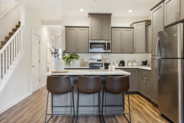 2828 22nd Ave Unit 10, Forest Grove, OR 97116 - kitchen featuring appliances with stainless steel finishes, wood finished floors, light countertops, a sink, and recessed lighting