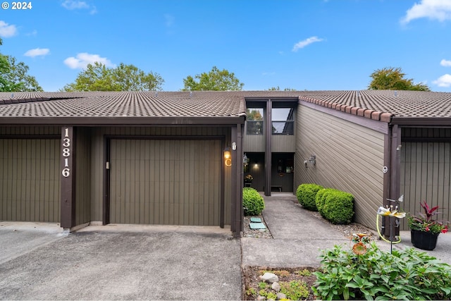 view of front of home with a garage and concrete driveway