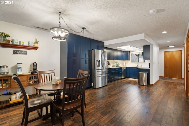 living room with a textured ceiling, wood finished floors, and visible vents