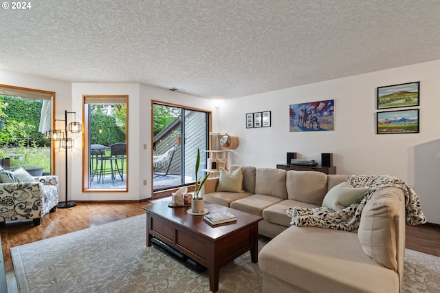 bedroom with a textured ceiling, visible vents, and wood finished floors