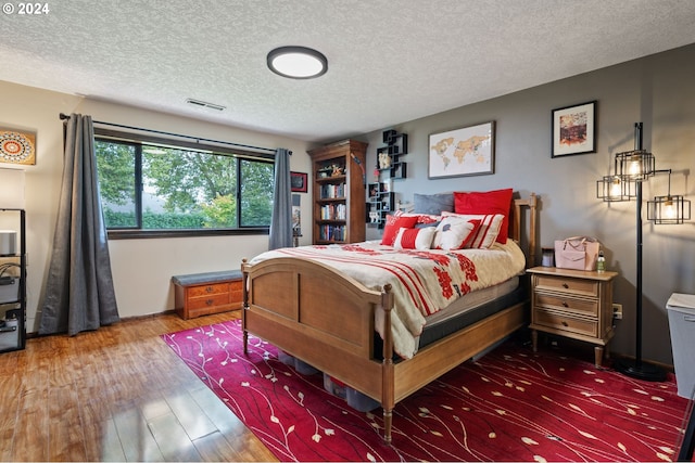 bathroom featuring a textured ceiling, hardwood / wood-style flooring, and vanity