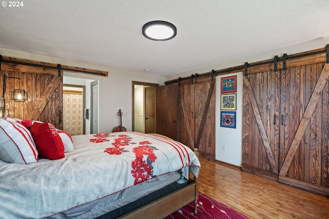 bathroom with toilet, curtained shower, wood finished floors, and vanity