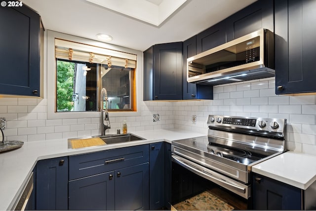 kitchen featuring stainless steel appliances, blue cabinetry, and tasteful backsplash