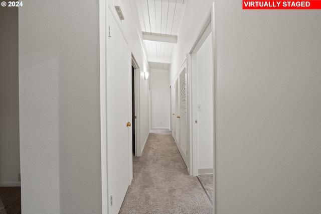 corridor featuring light colored carpet and visible vents