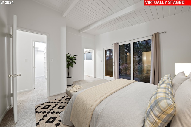 carpeted bedroom with access to outside, beam ceiling, and baseboards