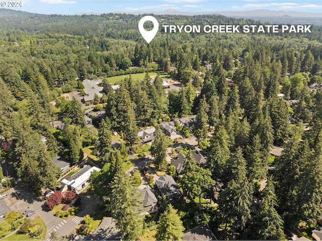 birds eye view of property featuring a wooded view and a residential view