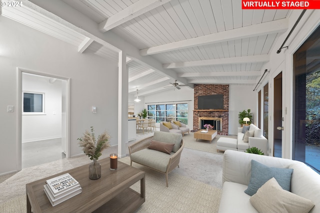 carpeted living room with a fireplace, a ceiling fan, and vaulted ceiling with beams