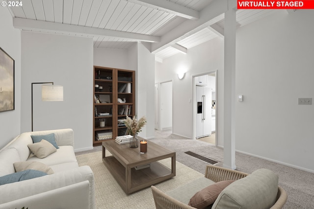 living room with light carpet, baseboards, and lofted ceiling with beams