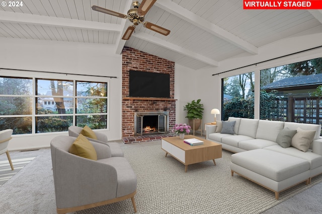 living area featuring lofted ceiling with beams, visible vents, ceiling fan, a fireplace, and carpet floors