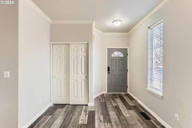 foyer entrance featuring crown molding and dark hardwood / wood-style flooring