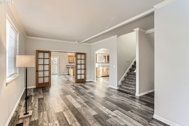 unfurnished room featuring dark hardwood / wood-style flooring, crown molding, and french doors