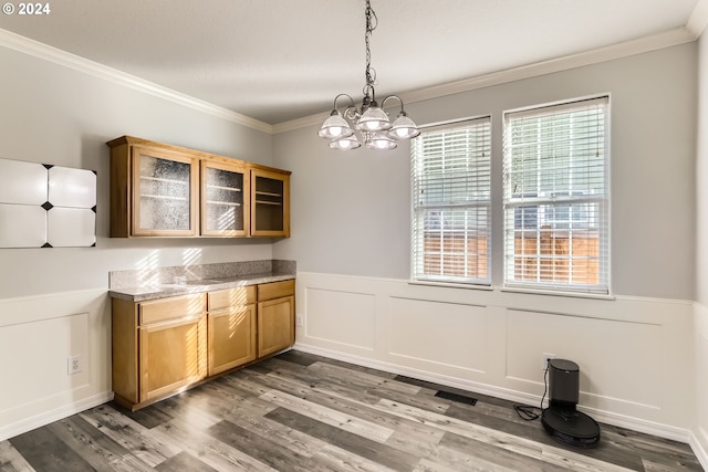 kitchen featuring a chandelier, wood-type flooring, decorative light fixtures, and ornamental molding