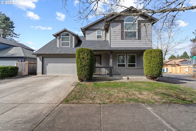 view of front of house featuring a garage, covered porch, fence, and concrete driveway