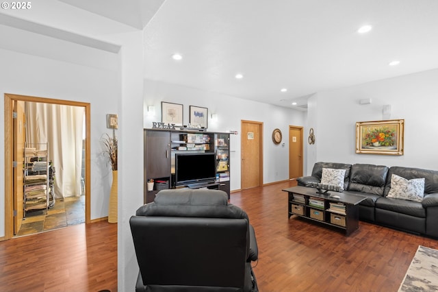 living room featuring recessed lighting, baseboards, and wood finished floors