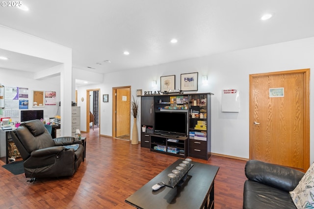 living room with recessed lighting, baseboards, and wood finished floors