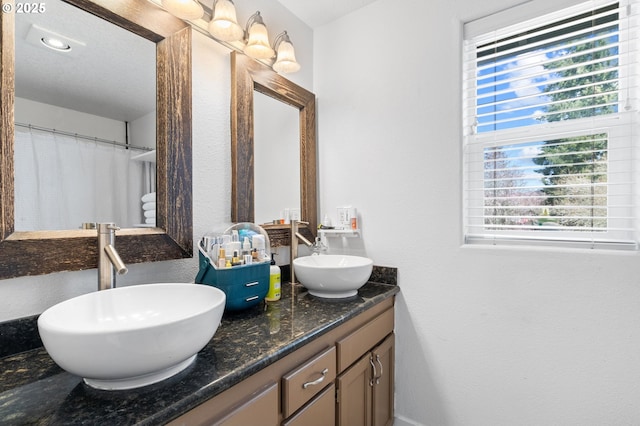 bathroom featuring double vanity and a sink