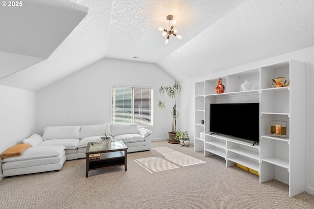 living area with lofted ceiling, a textured ceiling, a notable chandelier, visible vents, and carpet