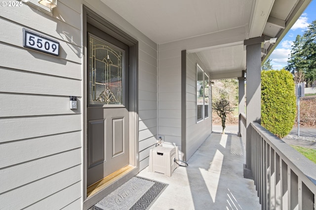 view of exterior entry with a porch