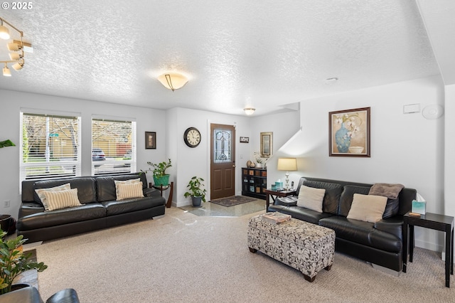 living room featuring carpet, baseboards, and a textured ceiling