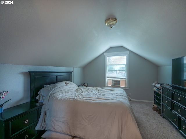 bedroom with vaulted ceiling and light carpet