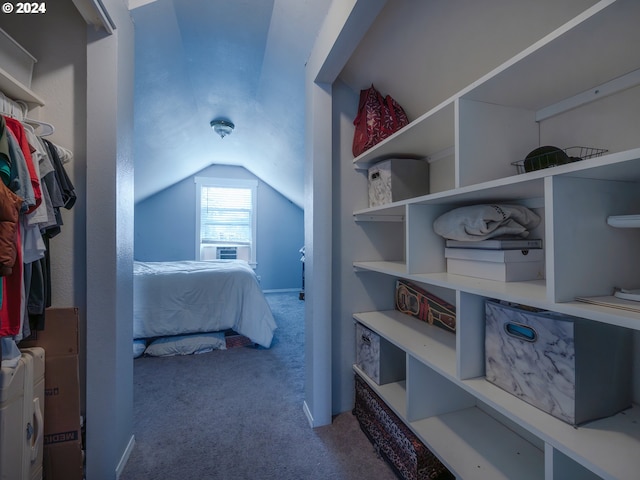 bedroom with cooling unit, vaulted ceiling, and carpet flooring