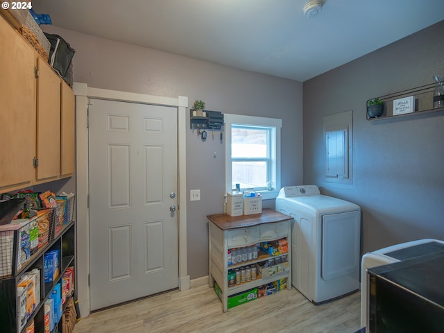 laundry area featuring light wood-type flooring and washer / clothes dryer