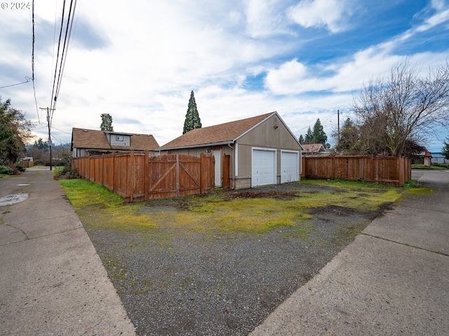 exterior space with an outbuilding and a garage