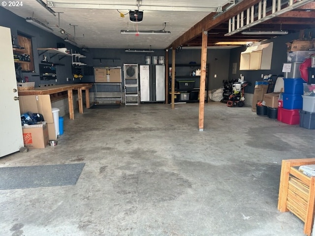 garage with a garage door opener and a workshop area