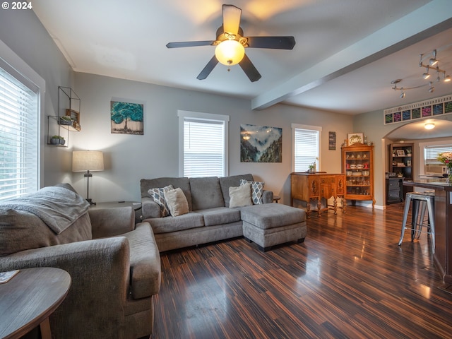 living room featuring beamed ceiling, ceiling fan, and dark hardwood / wood-style flooring