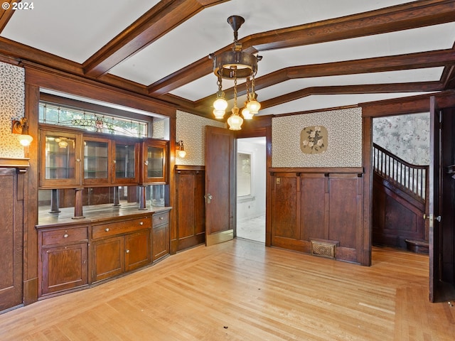 kitchen featuring lofted ceiling with beams, hanging light fixtures, an inviting chandelier, and light hardwood / wood-style flooring