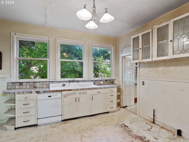 kitchen with white cabinets, white dishwasher, decorative light fixtures, and a healthy amount of sunlight