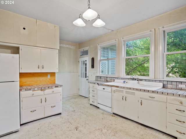 kitchen featuring tasteful backsplash, white appliances, decorative light fixtures, tile countertops, and white cabinets