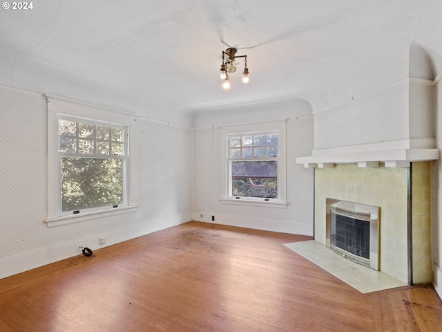 unfurnished living room featuring a fireplace and wood-type flooring