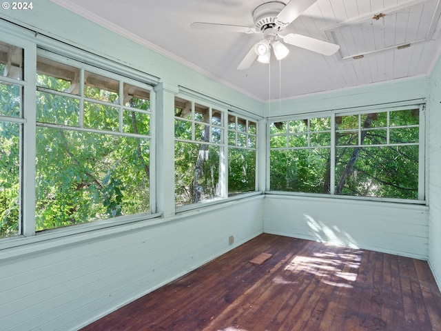 unfurnished sunroom with rail lighting and ceiling fan