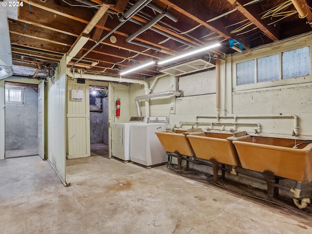 basement featuring washing machine and dryer and sink