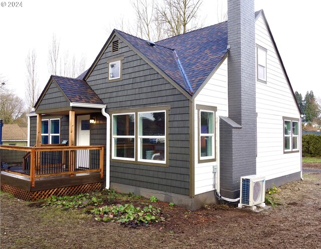 back of house with a deck and ac unit