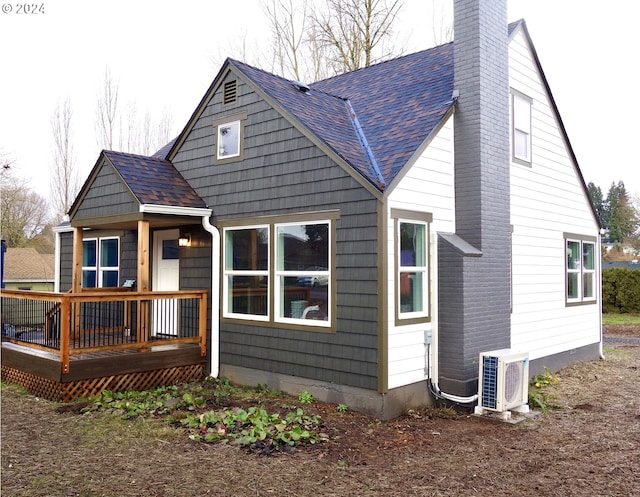 back of property with ac unit and a deck