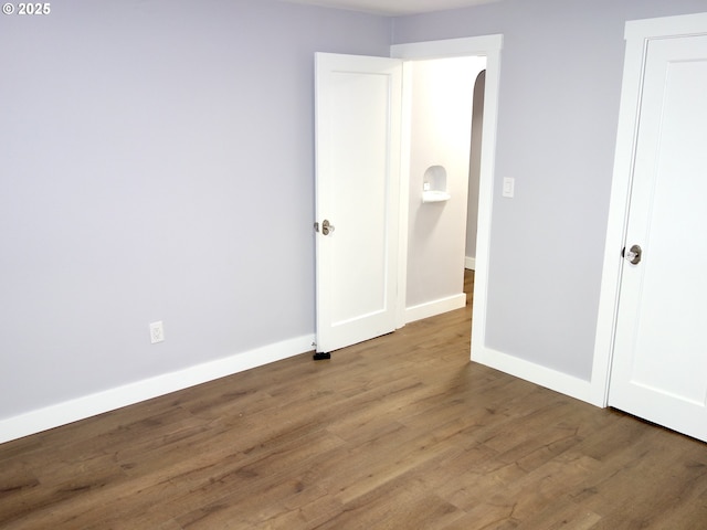 unfurnished bedroom with wood-type flooring